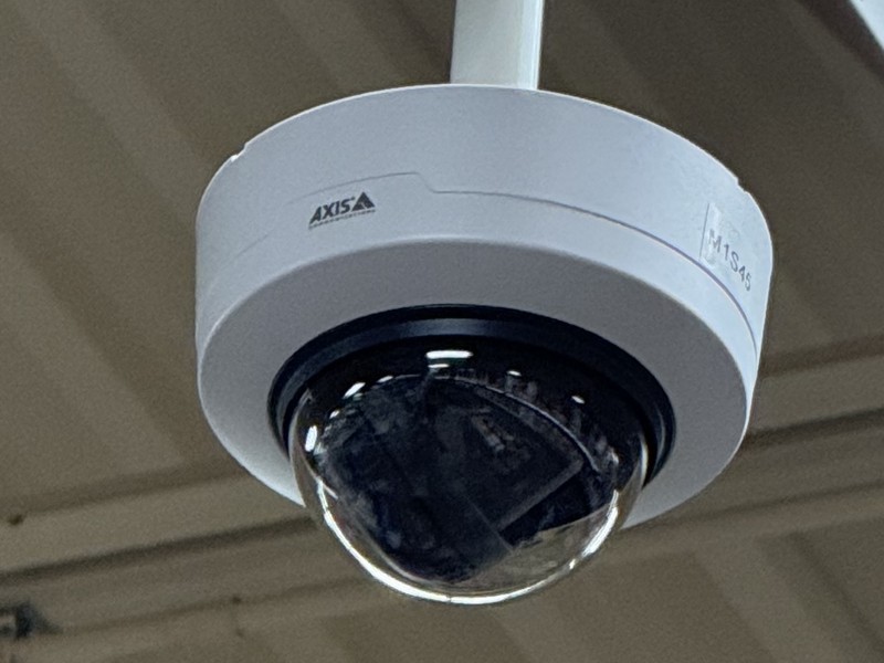 Axis M-Series dome security camera pendant-mounted from the ceiling of a commercial facility, installed by Michigan Security Systems