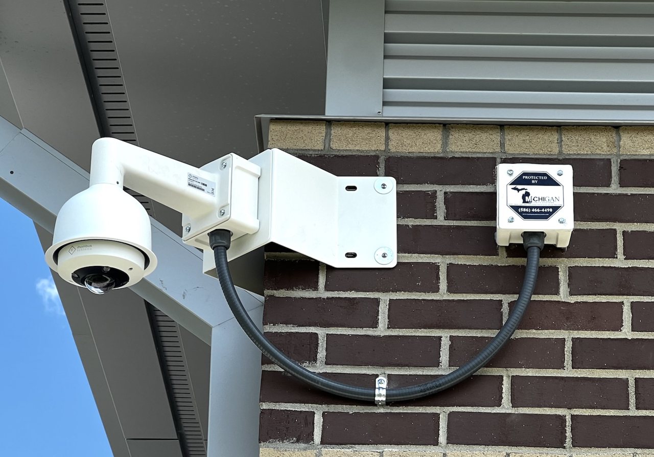 Camera with Protected By sign government facility