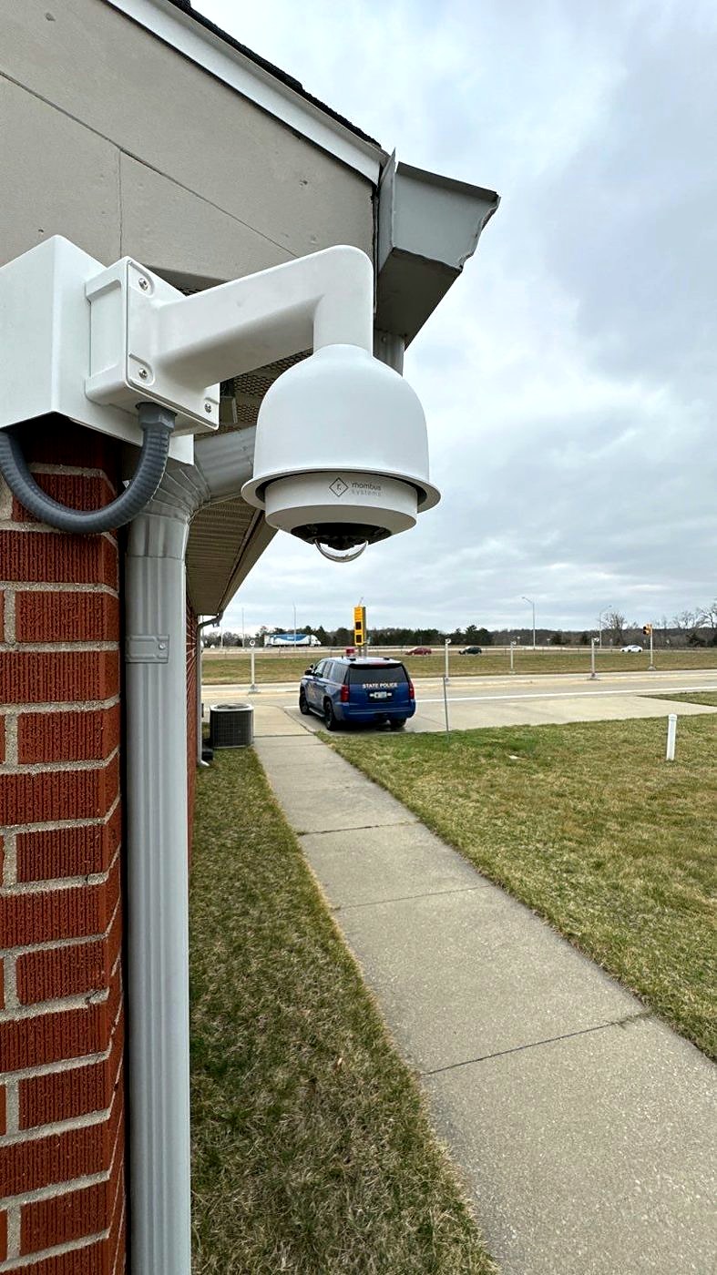 Commercial Security Camera Installation | Michigan Security Systems PTZ dome security camera installed on a commercial building — Michigan Security Systems commercial security camera installation